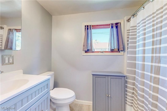 441 4th St, Bergholz, OH 43908 - bathroom featuring toilet, baseboards, plenty of natural light, and vanity