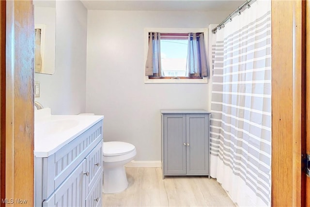 441 4th St, Bergholz, OH 43908 - bathroom with a shower with curtain, wood finished floors, vanity, baseboards, and toilet
