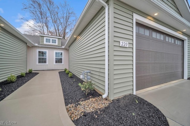 entrance to property featuring concrete driveway