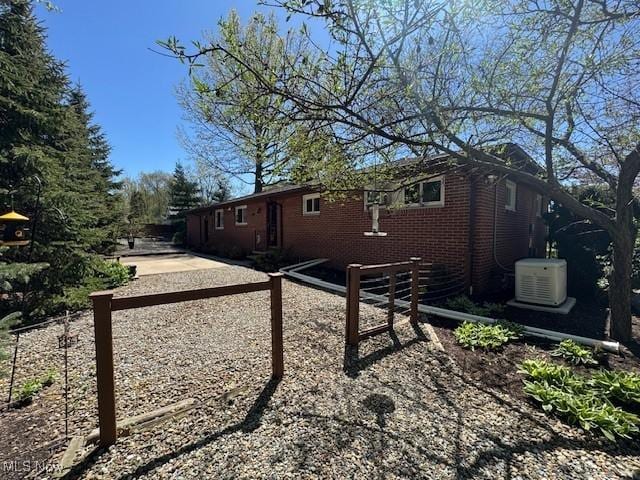view of side of home featuring brick siding