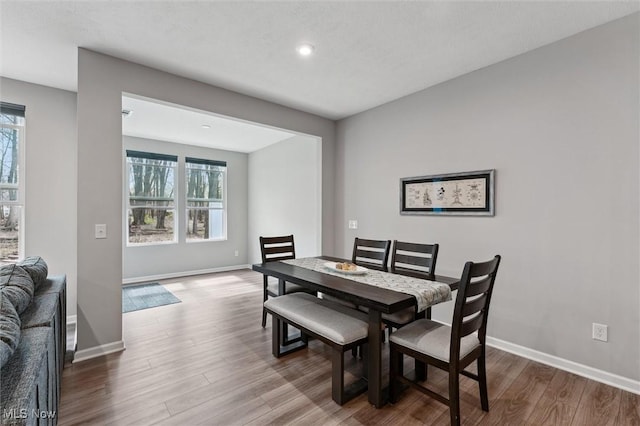 dining area featuring baseboards, recessed lighting, and wood finished floors