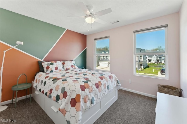 bedroom featuring baseboards, a ceiling fan, carpet flooring, and visible vents