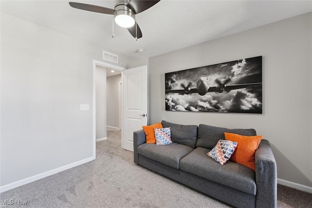carpeted living area with baseboards, a ceiling fan, and visible vents
