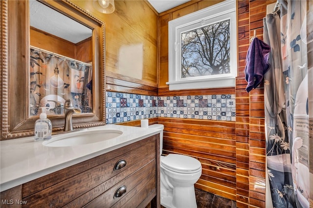 8935 S Main St, Windham, OH 44288 - bathroom with vanity, a shower with shower curtain, wooden walls, and toilet