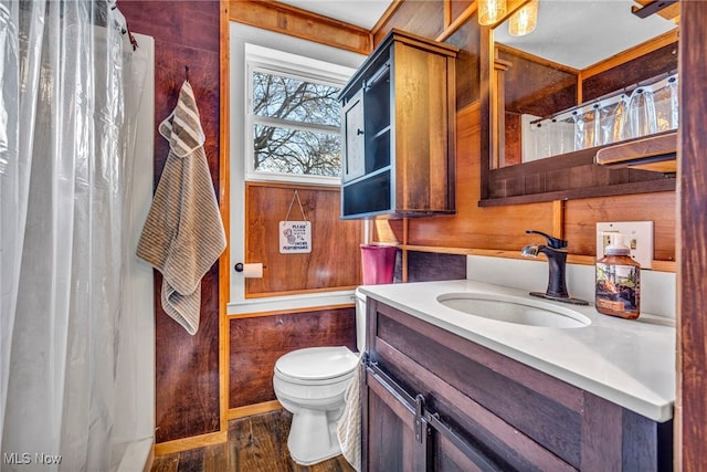 8935 S Main St, Windham, OH 44288 - bathroom with vanity, wood finished floors, curtained shower, toilet, and wooden walls