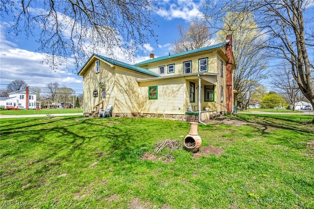 8935 S Main St, Windham, OH 44288 - view of front of house with a front lawn, covered porch, a chimney, and entry steps