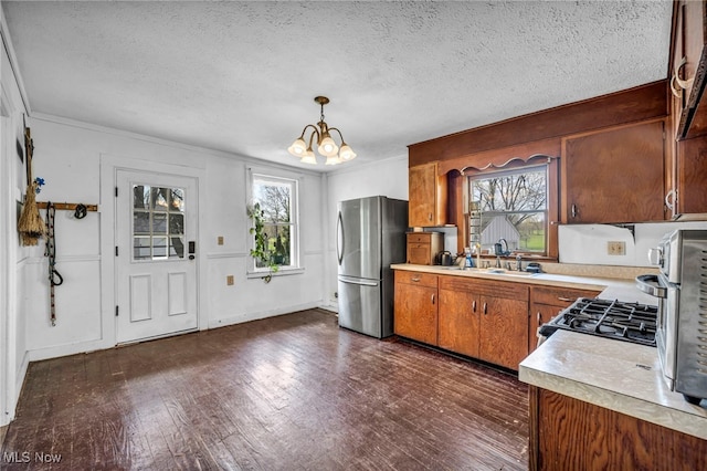 8935 S Main St, Windham, OH 44288 - kitchen featuring light countertops, freestanding refrigerator, a textured ceiling, and a notable chandelier