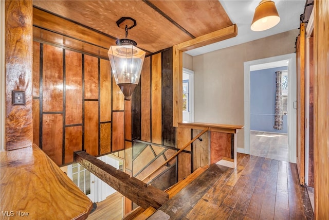 8935 S Main St, Windham, OH 44288 - corridor featuring baseboards, wood-type flooring, a barn door, and an upstairs landing