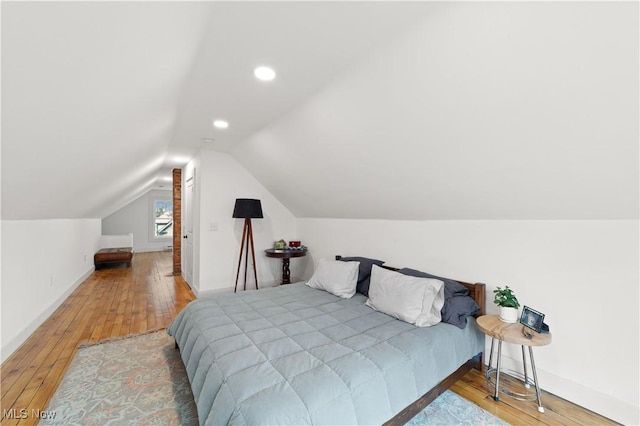 bedroom featuring wood-type flooring, recessed lighting, baseboards, and lofted ceiling