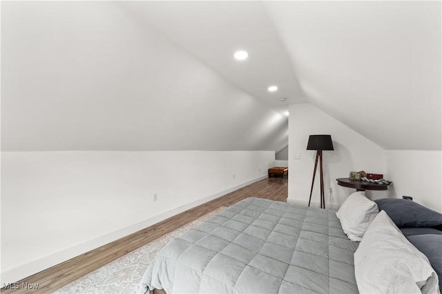 bedroom featuring wood finished floors, recessed lighting, baseboards, and lofted ceiling