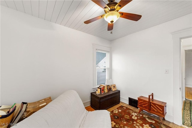 bedroom featuring a ceiling fan, baseboards, visible vents, and wood finished floors