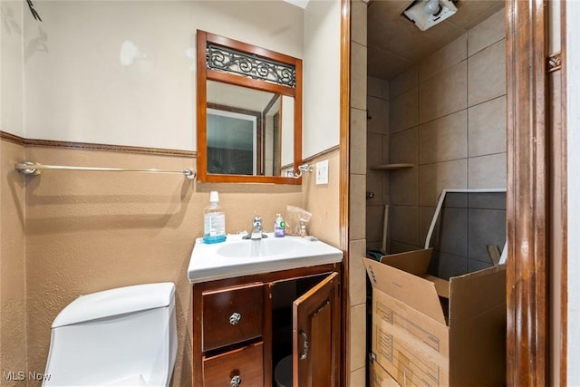 bathroom with toilet and vanity