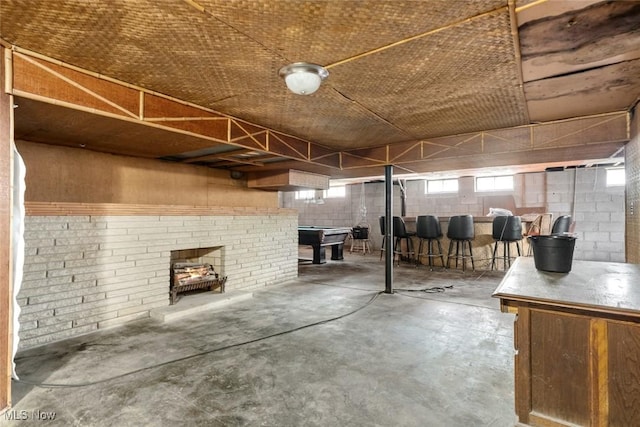 below grade area with concrete block wall and billiards