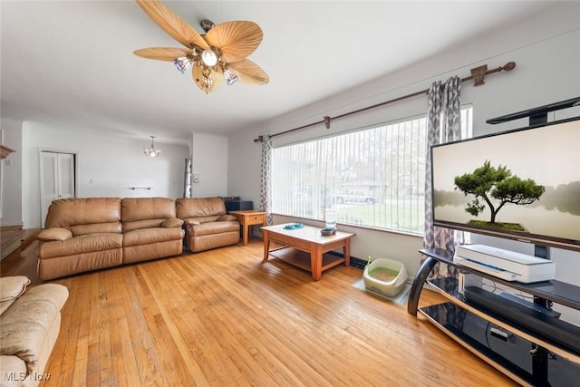 living area featuring light wood-type flooring and ceiling fan