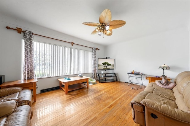 living area with ceiling fan and light wood finished floors