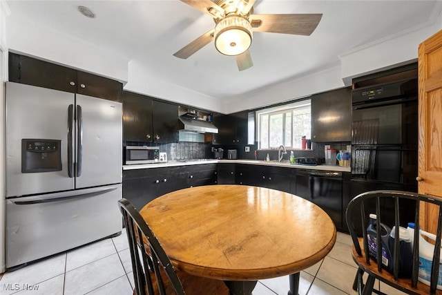 kitchen with under cabinet range hood, light tile patterned flooring, black appliances, and tasteful backsplash