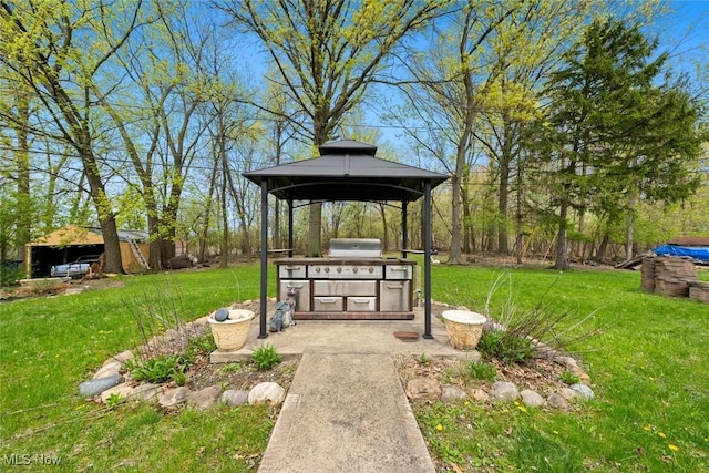 view of property's community with a yard, an outdoor kitchen, a gazebo, and fence