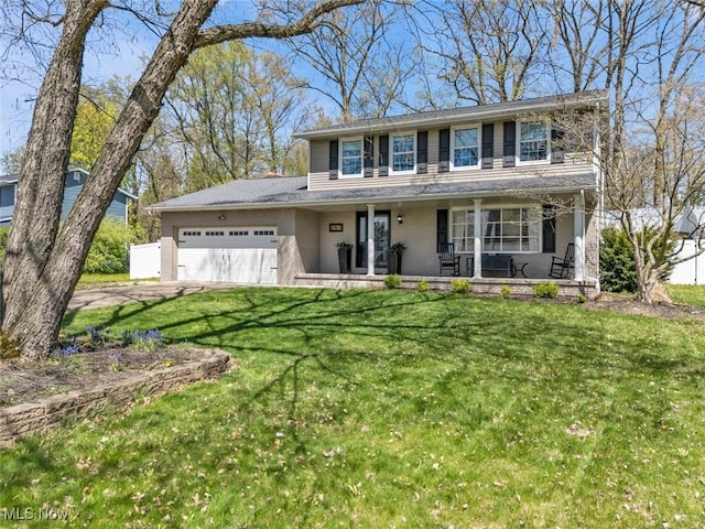 traditional-style house featuring an attached garage, a front lawn, brick siding, a porch, and driveway