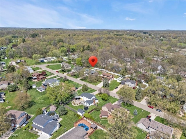 bird's eye view featuring a residential view and a wooded view