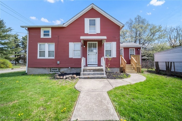 view of front of home featuring fence and a front yard