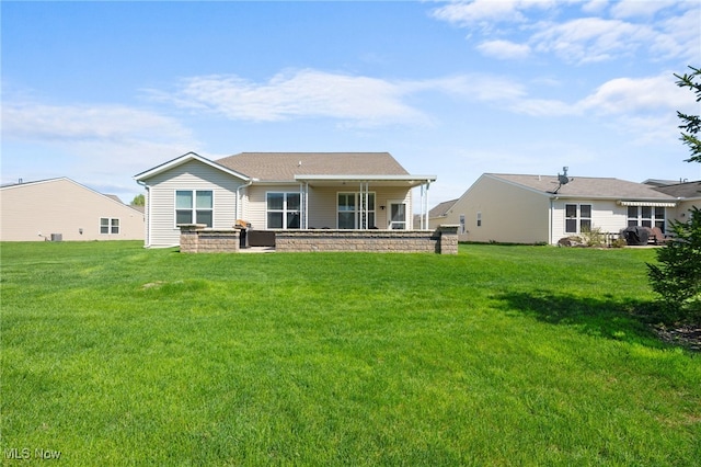 rear view of property with a lawn