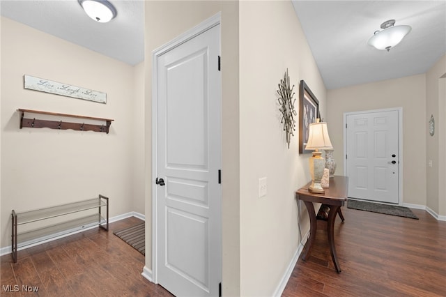 hall featuring baseboards and wood finished floors