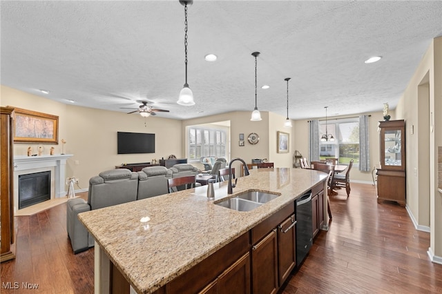 kitchen with a textured ceiling, a sink, and dishwasher