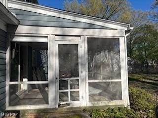 view of outdoor structure featuring a sunroom
