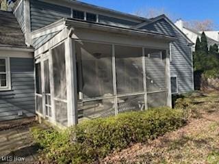 view of side of property with a sunroom