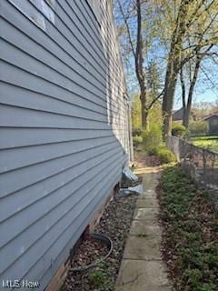 view of side of property featuring fence