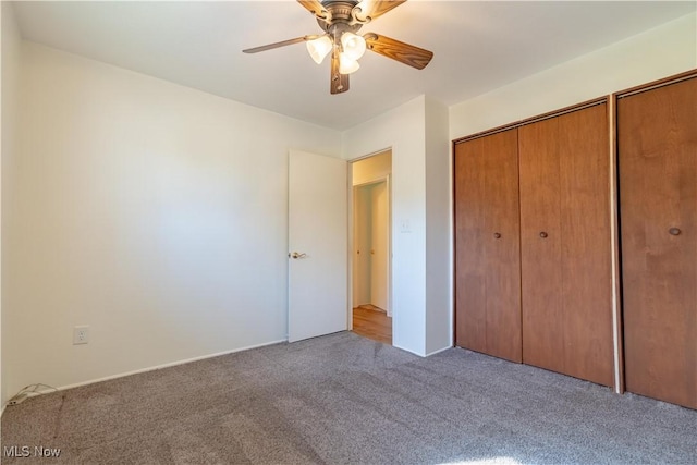unfurnished bedroom featuring carpet floors and ceiling fan
