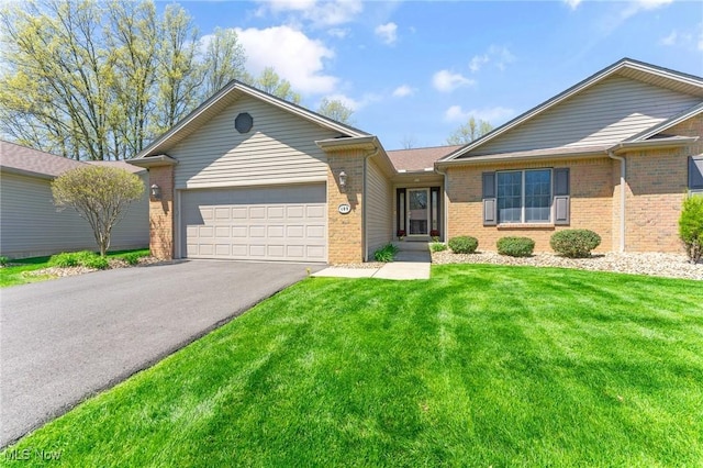 409 Pin Oak Pl, Campbell, OH 44405 - ranch-style home featuring brick siding, an attached garage, a front lawn, and aphalt driveway