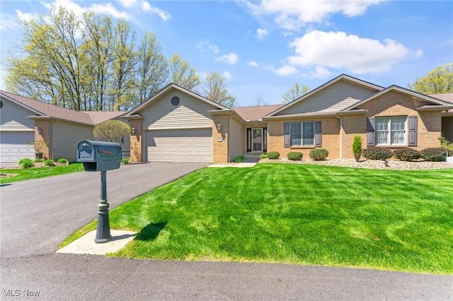 409 Pin Oak Pl, Campbell, OH 44405 - single story home featuring brick siding, aphalt driveway, a front lawn, and an attached garage