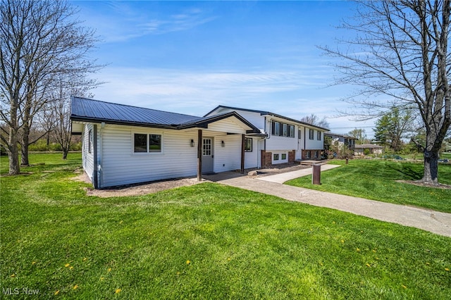6084 Clay St, Thompson, OH 44086 - tri-level home with metal roof and a front lawn