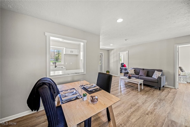 6084 Clay St, Thompson, OH 44086 - dining room featuring baseboards, recessed lighting, a textured ceiling, and wood finished floors