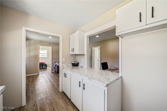 6084 Clay St, Thompson, OH 44086 - kitchen featuring white cabinets, light countertops, recessed lighting, baseboards, and wood finished floors