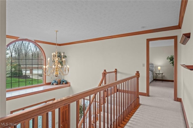 275 Camden Ln, Aurora, OH 44202 - corridor with carpet flooring, a textured ceiling, a chandelier, baseboards, and an upstairs landing