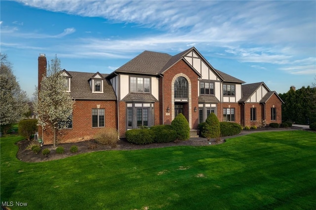275 Camden Ln, Aurora, OH 44202 - view of front of house with brick siding, a chimney, and a front yard