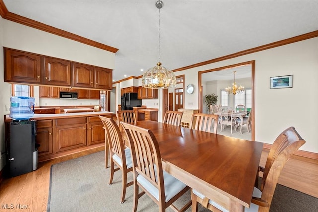 275 Camden Ln, Aurora, OH 44202 - dining space featuring an inviting chandelier, ornamental molding, and light wood-type flooring