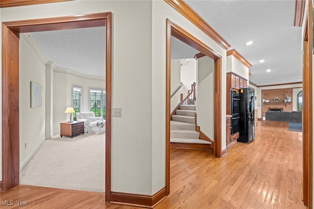 275 Camden Ln, Aurora, OH 44202 - hall featuring crown molding, stairs, recessed lighting, baseboards, and light wood-type flooring