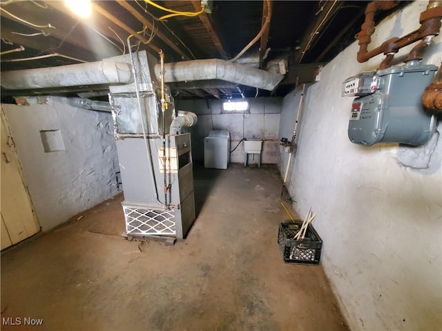 9615 Dunlap Ave, Cleveland, OH 44105 - unfinished basement featuring washer / dryer, heating unit, and a sink