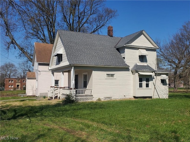9615 Dunlap Ave, Cleveland, OH 44105 - back of house featuring a porch, a shingled roof, a lawn, and a chimney