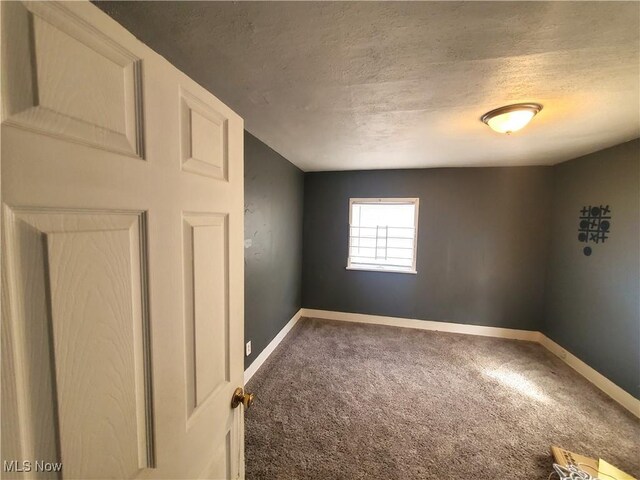 9615 Dunlap Ave, Cleveland, OH 44105 - spare room with baseboards, carpet, and a textured ceiling