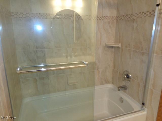 full bath featuring shower / bath combination with glass door