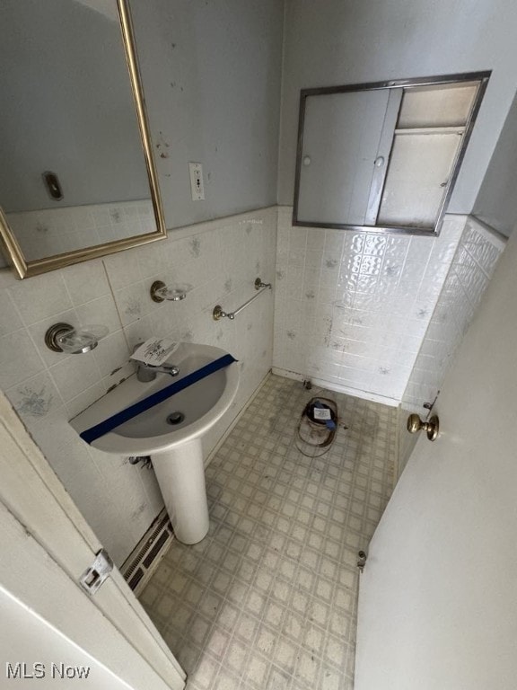 bathroom featuring tile walls and a wainscoted wall
