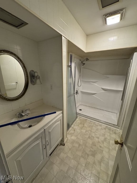 full bath with vanity and a shower