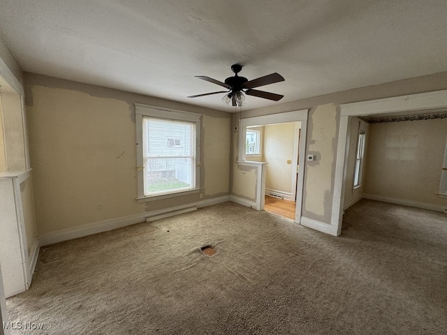 unfurnished bedroom featuring carpet floors, baseboards, and ceiling fan