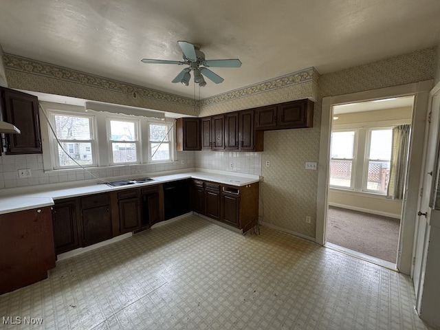 kitchen featuring ceiling fan, dark brown cabinetry, light countertops, baseboards, and wallpapered walls
