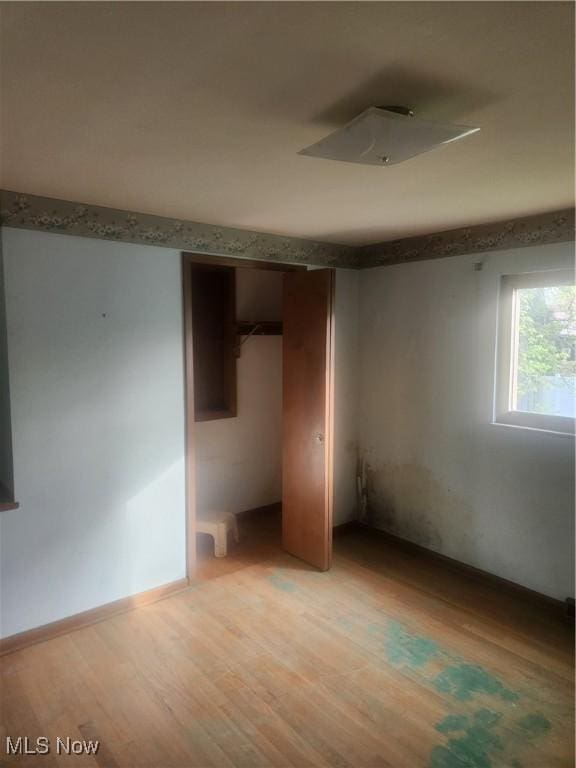 6876 Anthony Ln, Parma Heights, OH 44130 - unfurnished bedroom with a closet and light wood-style floors
