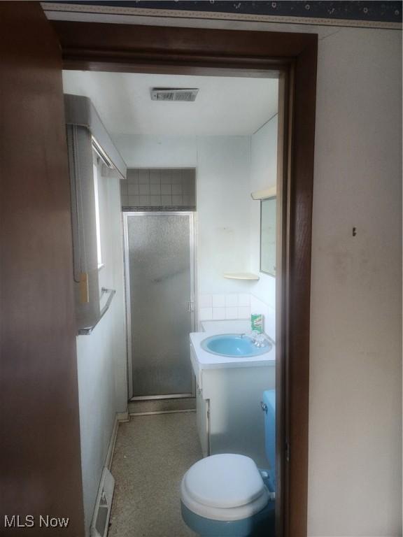 6876 Anthony Ln, Parma Heights, OH 44130 - bathroom featuring visible vents, a stall shower, vanity, baseboards, and toilet